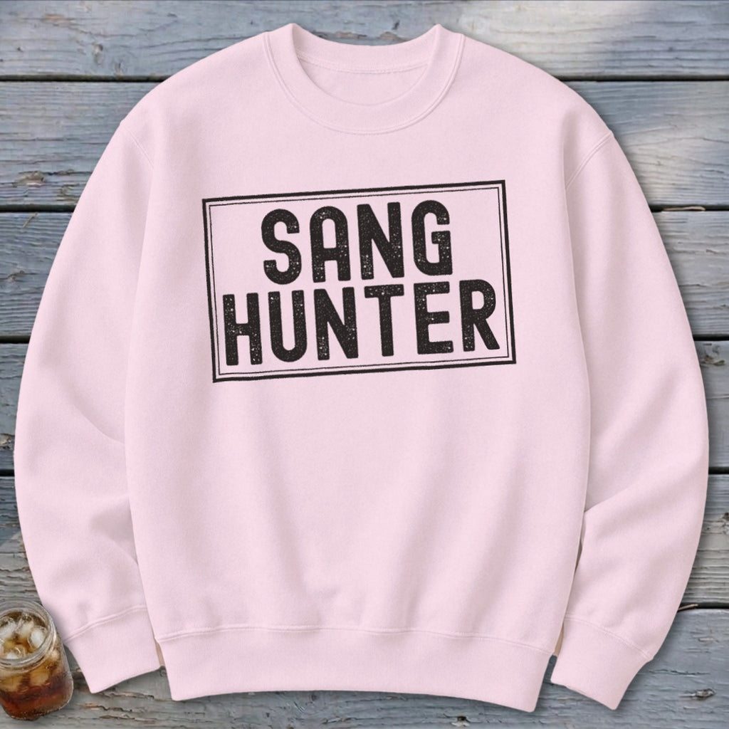Light pink sweatshirt with black text that reads "SANG HUNTER" inside a rectangle.