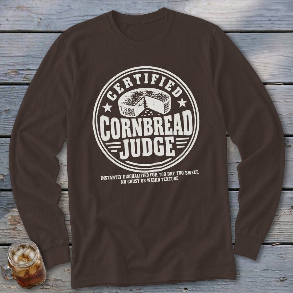 Brown long-sleeve t-shirt with a white circular graphic reading Certified Cornbread Judge and disqualification criteria below.