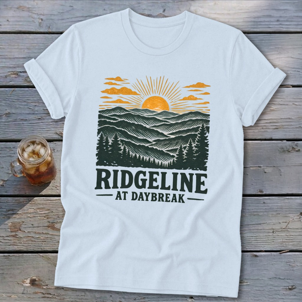 White t-shirt with "RIDGELINE AT DAYBREAK" graphic of a sunrise over mountains.