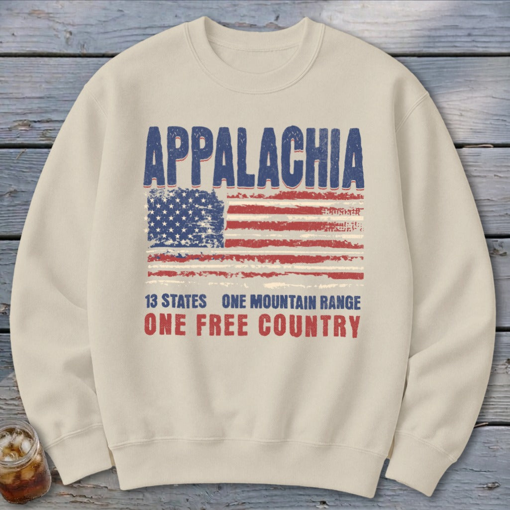 Beige crewneck sweatshirt featuring a distressed American flag graphic and the text Appalachia, 13 States, One Mountain Range, One Free Country.