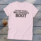 Pink t-shirt with "COLDER THAN A WELLDIGGER'S BOOT" printed in black.