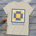 Cream t-shirt with blue and yellow "Churn Dash" quilt block design.