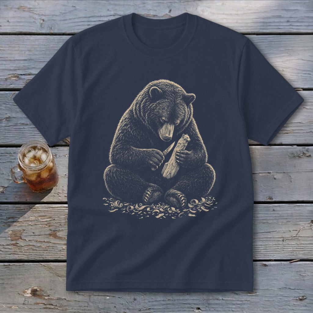 Navy t-shirt featuring a bear carving wood with a knife.
