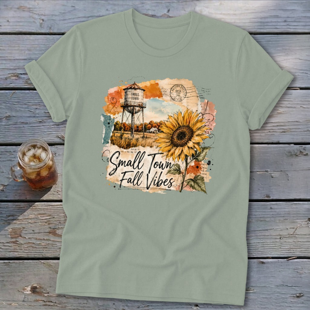 T-shirt graphic with sunflower, water tower, and text "Small Town Fall Vibes."