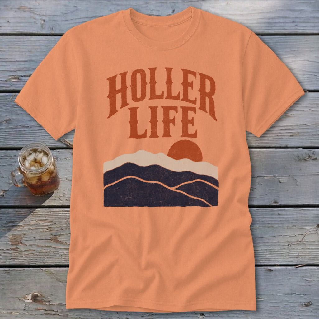 An orange crewneck t-shirt featuring a retro mountain graphic and the text Holler Life.