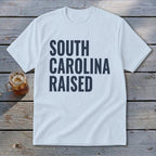 Light blue t-shirt with "SOUTH CAROLINA RAISED" in dark blue lettering.