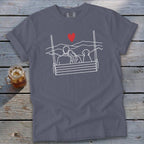 Adults and dog on swing with red heart above mountains, white outline graphic.
