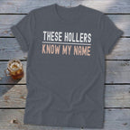 Gray t-shirt with text "THESE HOLLERS KNOW MY NAME"