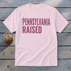Light pink t-shirt with "PENNSYLVANIA RAISED" in dark pink text.