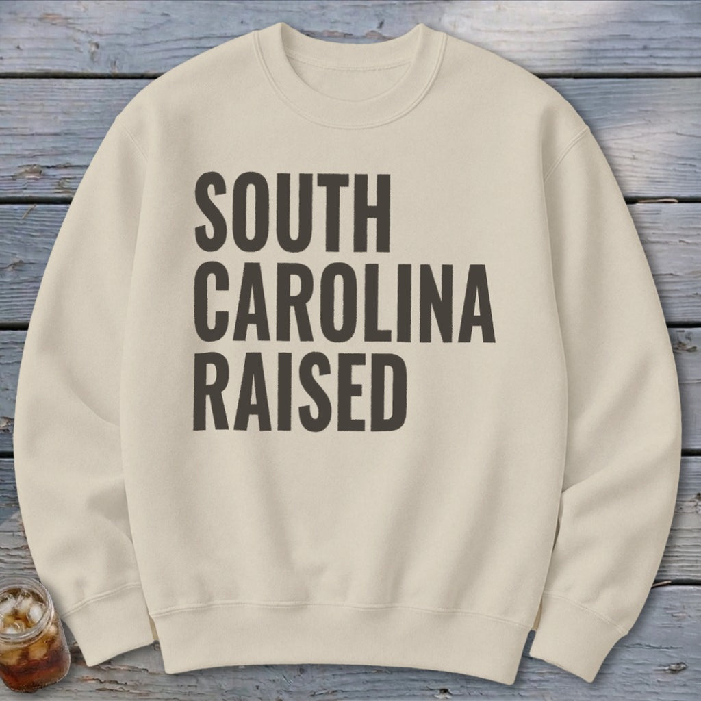 Cream sweatshirt with "SOUTH CAROLINA RAISED" text in dark gray.