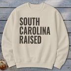 Cream sweatshirt with "SOUTH CAROLINA RAISED" text in dark gray.