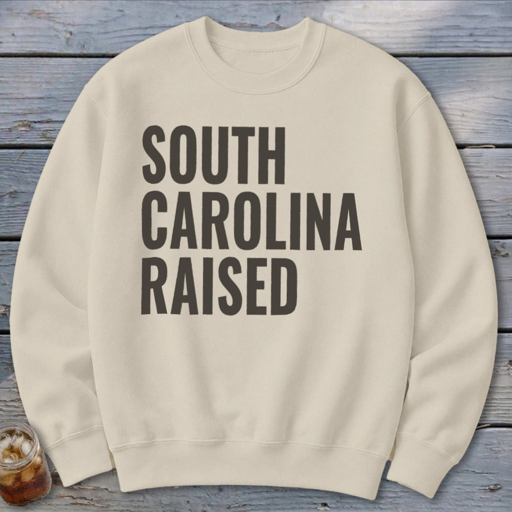 Cream sweatshirt with "SOUTH CAROLINA RAISED" text in dark gray.