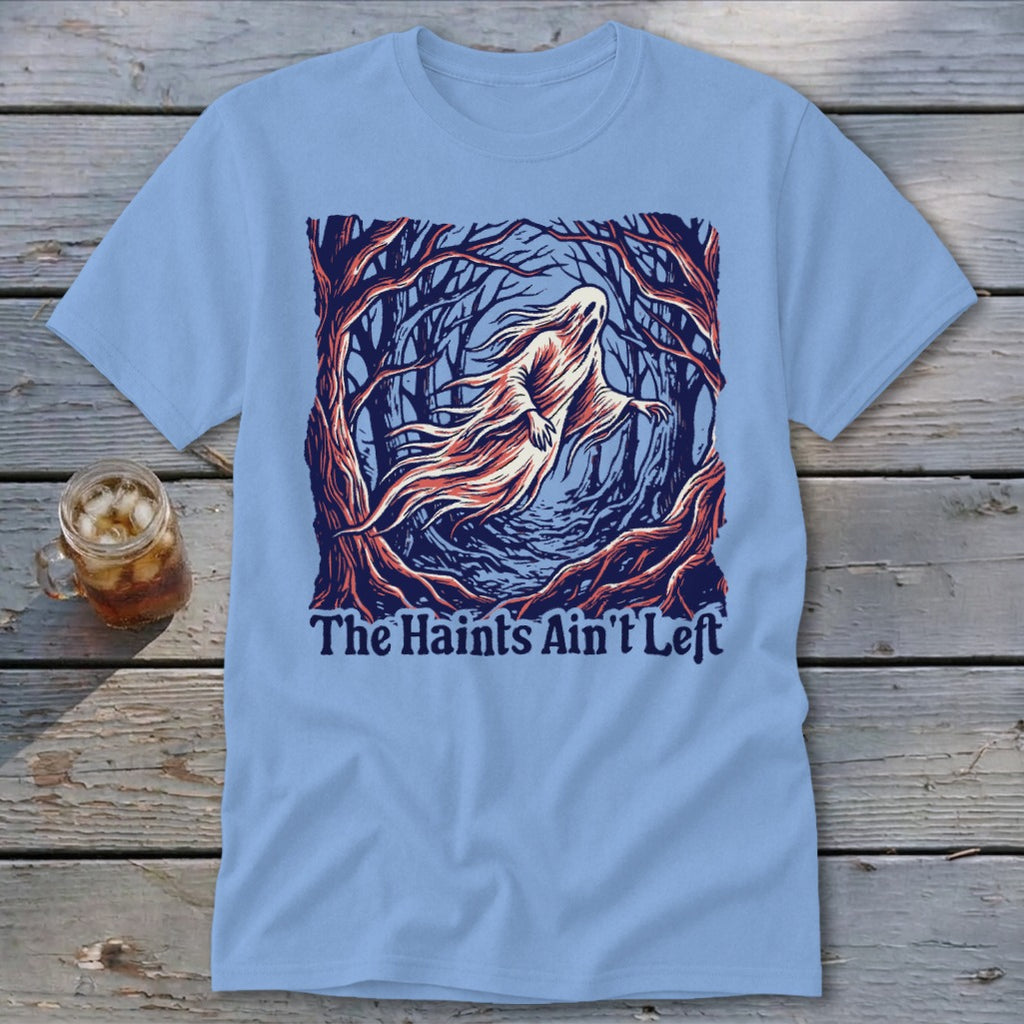 Light blue t-shirt with a ghost in a dark forest and text "The Haints Ain't Left."