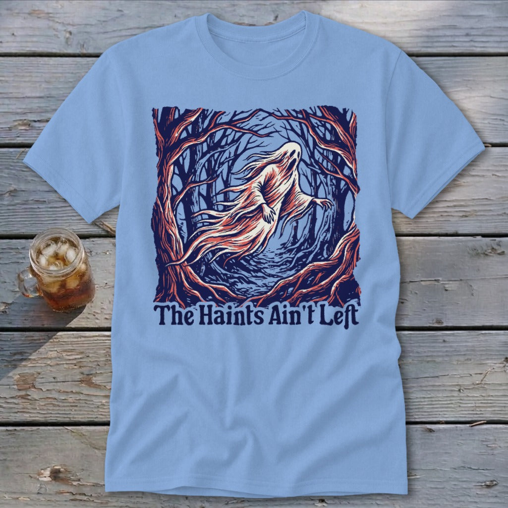 Light blue t-shirt with a ghost in a dark forest and text "The Haints Ain't Left."