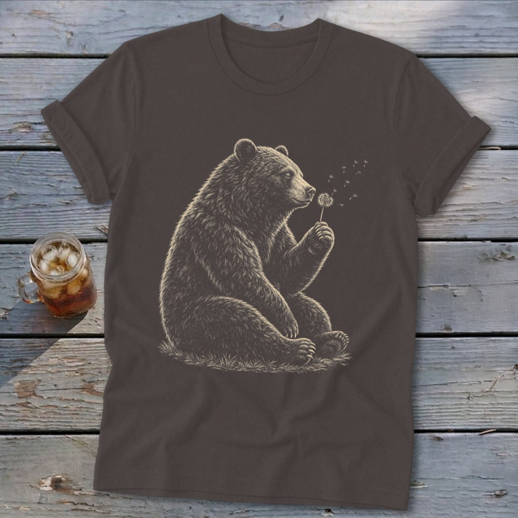 Brown t-shirt with a detailed illustration of a bear blowing on a dandelion puff.