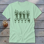 Light green t-shirt featuring a dark green graphic of four mason jars with wildflowers on a shelf.