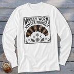 A white long-sleeved shirt features a black and brown graphic of a woolly worm with snowflakes, crescent moons, and text reading Woolly Worm Winter Prophet.