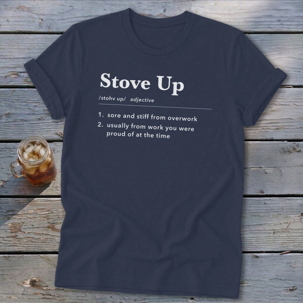 Dark blue t-shirt featuring the definition of "Stove Up" printed in white text on a wooden surface.