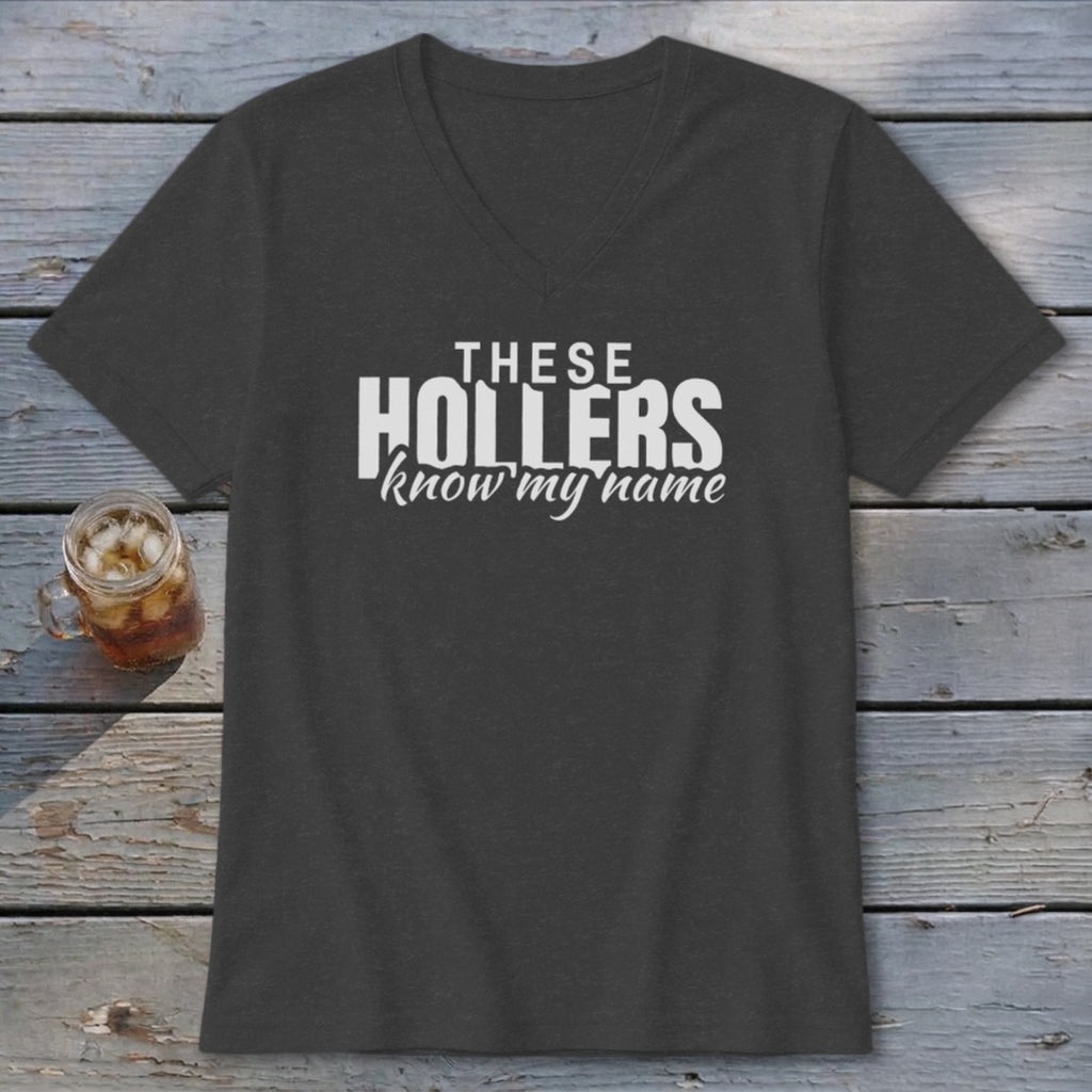 Dark grey v-neck t-shirt with white text reading "THESE HOLLERS know my name".
