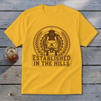Yellow t-shirt with brown graphic of a lantern and text "ESTABLISHED IN THE HILLS".