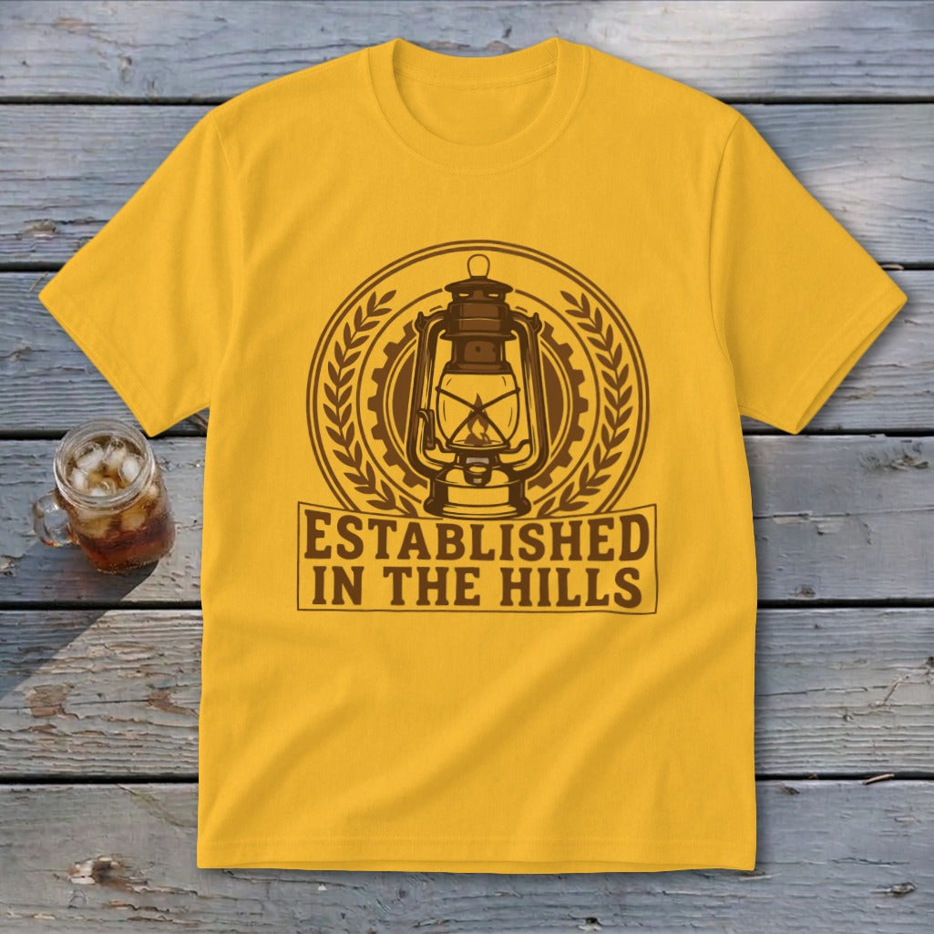 Yellow t-shirt with brown graphic of a lantern and text "ESTABLISHED IN THE HILLS".
