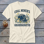 Cream t-shirt with "Coal Miner's Granddaughter" text and mining helmet with flowers.