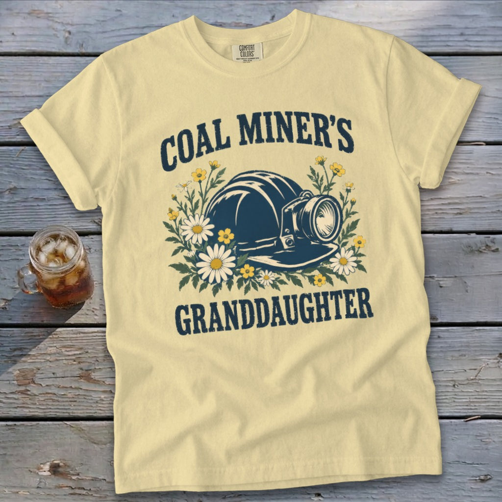 Pale yellow t-shirt with "Coal Miner's Granddaughter" text and mining helmet graphic.
