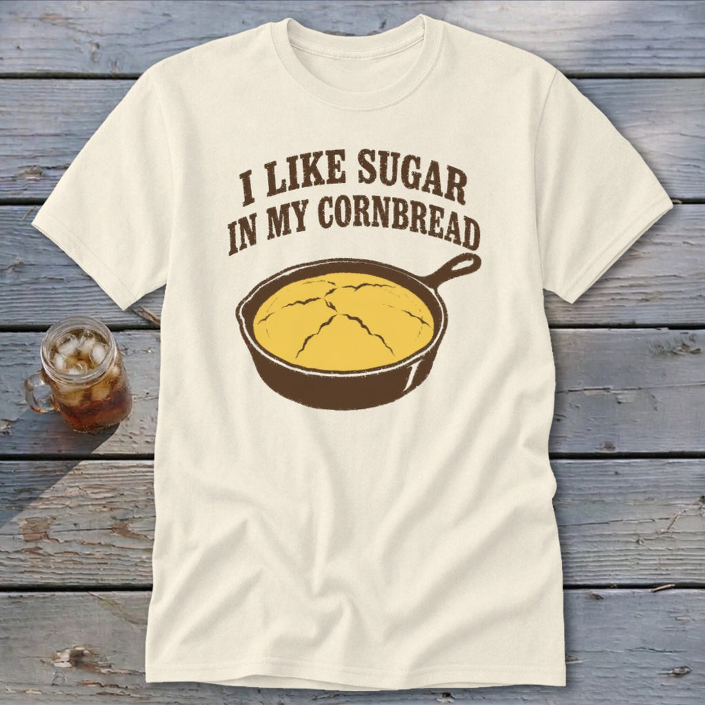 Cream t-shirt with text "I LIKE SUGAR IN MY CORNBREAD" and a cast iron skillet with cornbread.