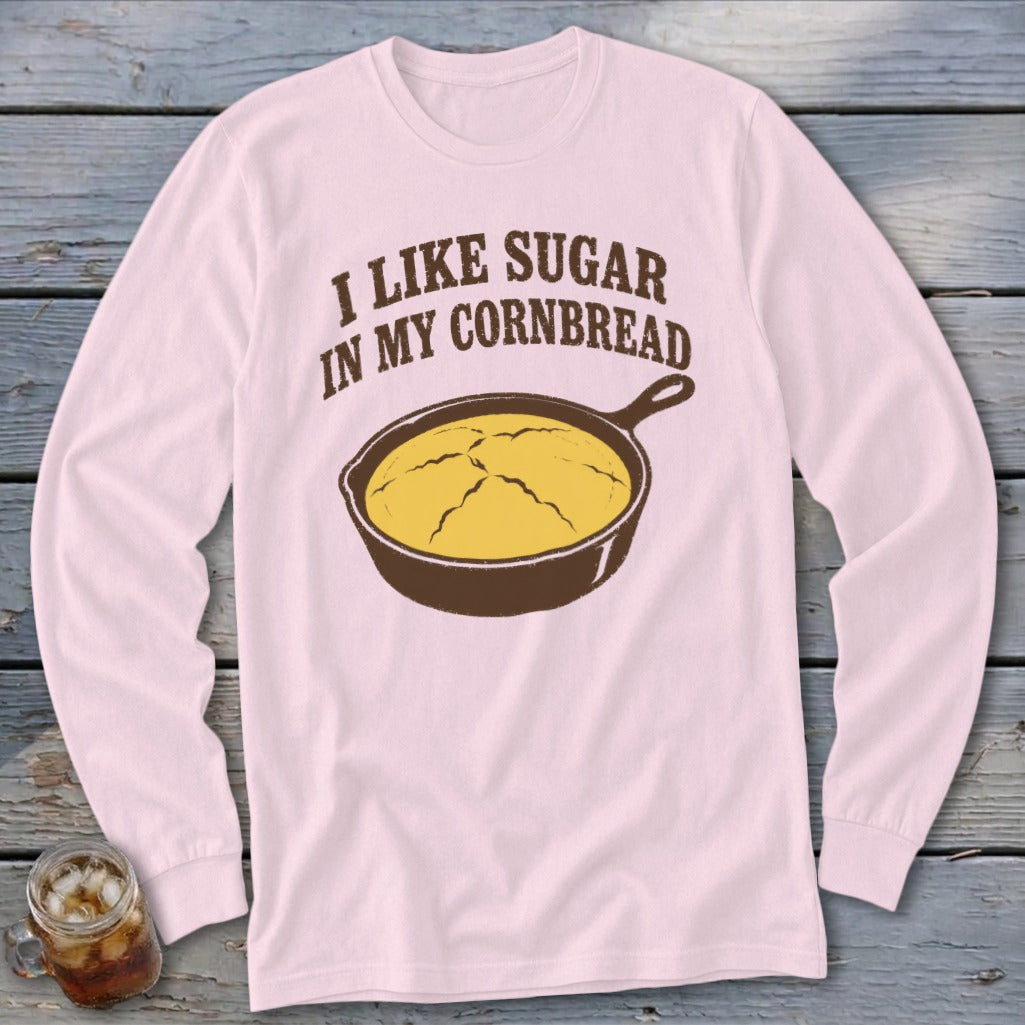 Pink long sleeve shirt with text "I LIKE SUGAR IN MY CORNBREAD" and a skillet of cornbread.