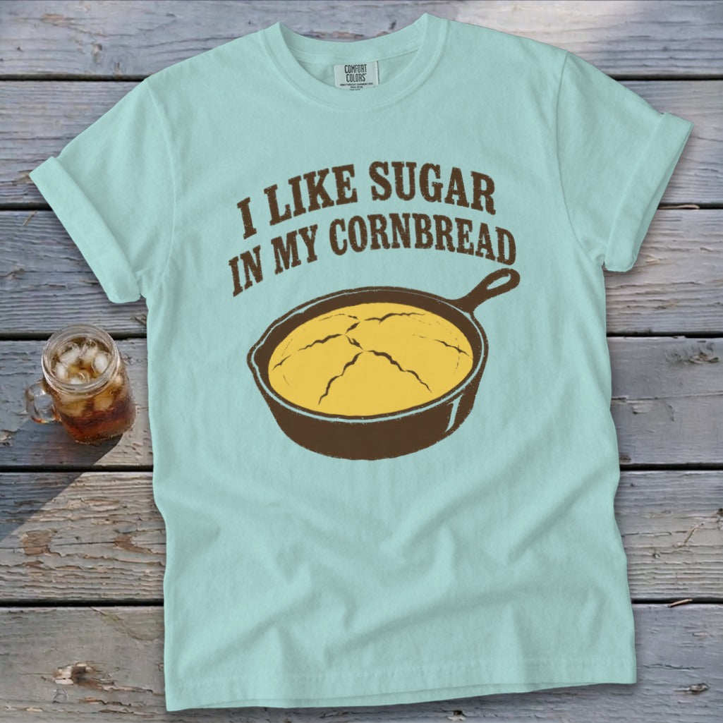 Light blue t-shirt with "I LIKE SUGAR IN MY CORNBREAD" and a skillet of cornbread.