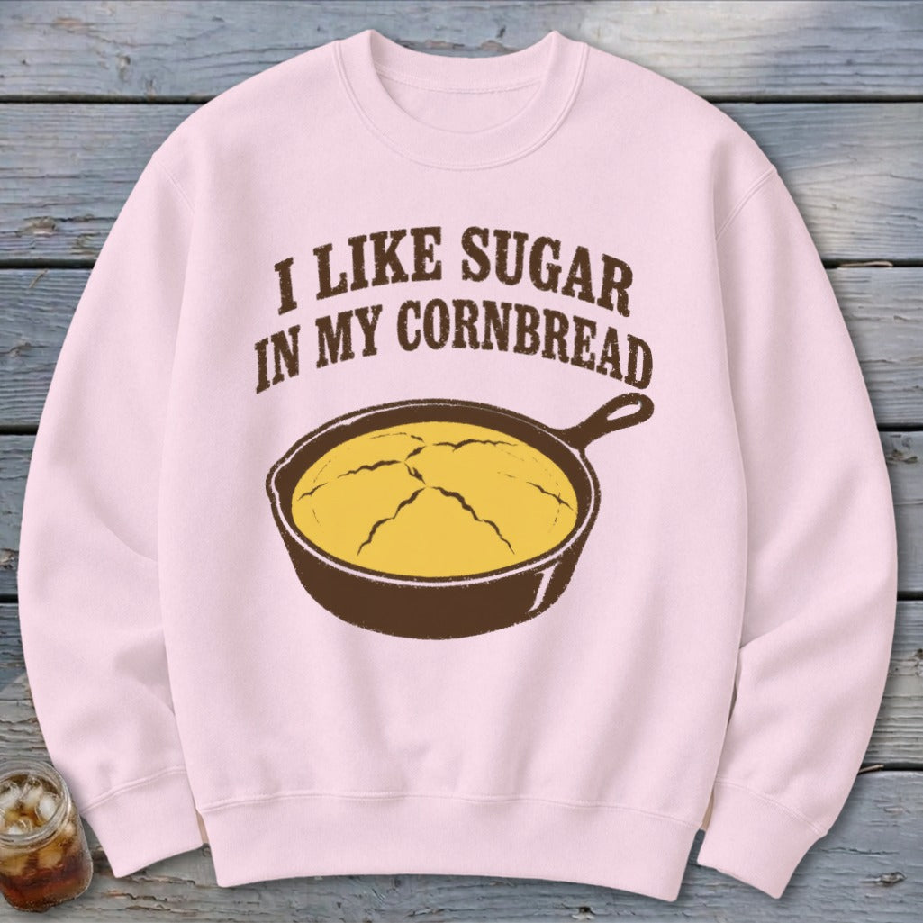 Light pink sweatshirt with text "I LIKE SUGAR IN MY CORNBREAD" and cast iron skillet graphic.
