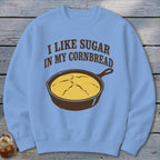 Light blue sweatshirt with "I like sugar in my cornbread" and a skillet of cornbread.