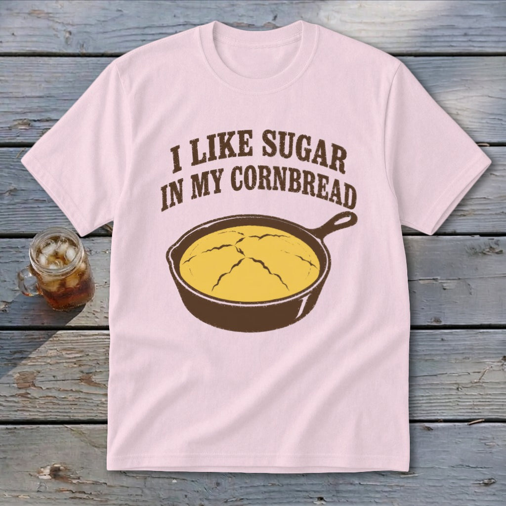 Pink t-shirt with "I Like Sugar In My Cornbread" and cast iron skillet graphic.