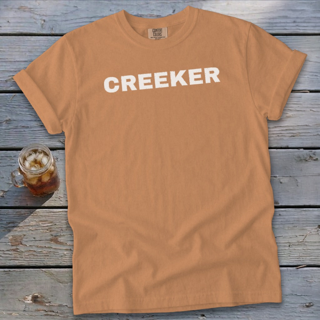 Orange t-shirt with white "CREEKER" text and Comfort Colors tag.