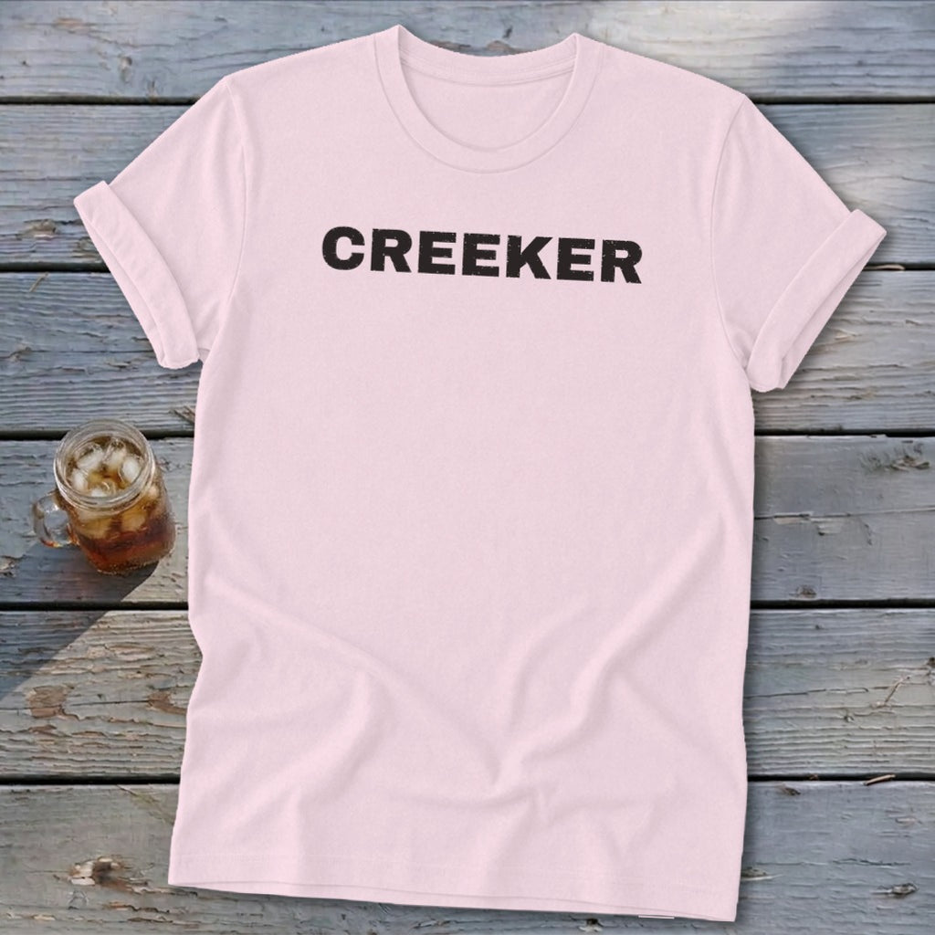 Pink t-shirt with black text "CREEKER" centered on the chest.