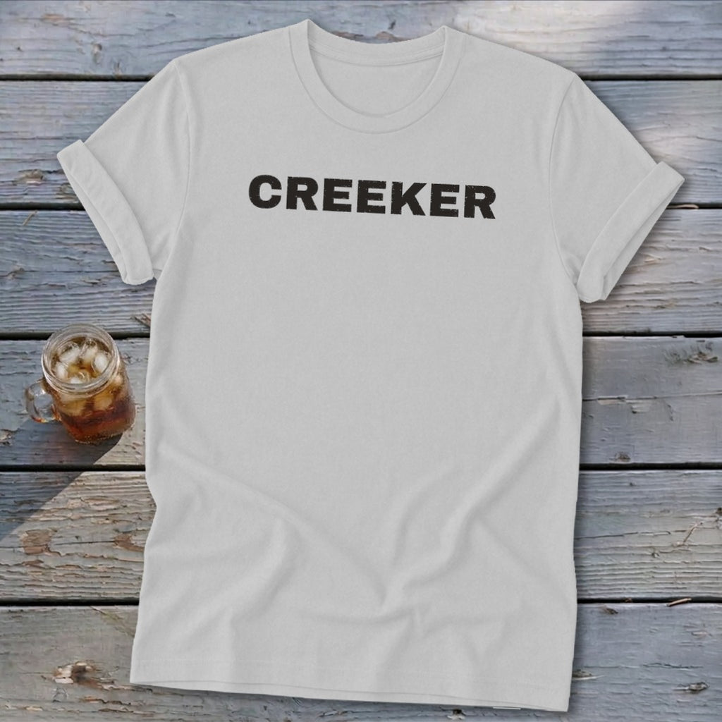 White t-shirt with "CREEKER" printed in black letters.