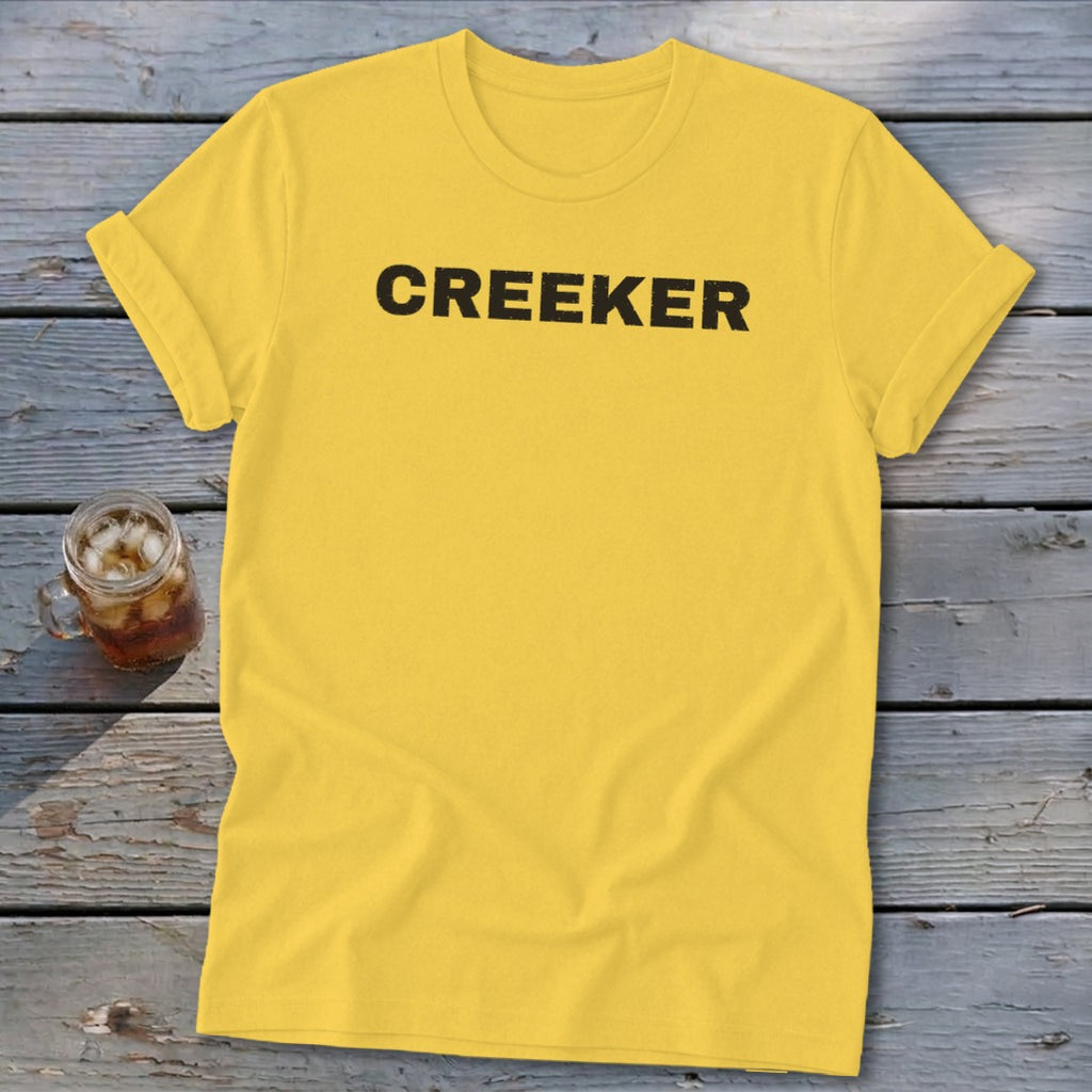 Yellow t-shirt with black text that says CREEKER.