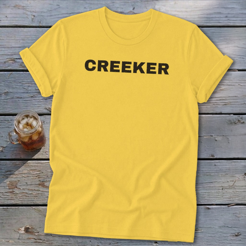 Yellow t-shirt with black text that says CREEKER.