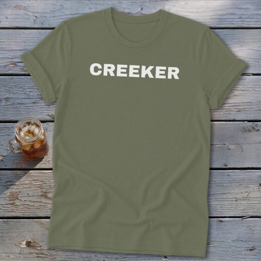 Olive green t-shirt with white "CREEKER" text on the front.