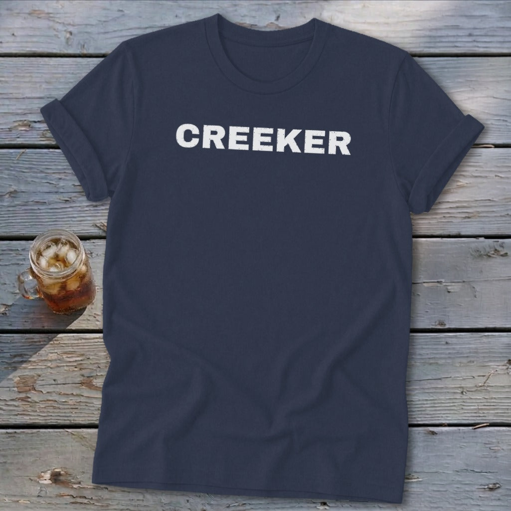 Navy t-shirt with white text that reads "CREEKER" and a glass of iced tea.