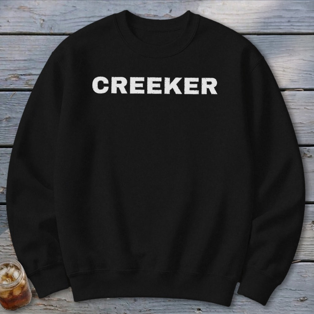 Black sweatshirt with white "CREEKER" text centered on the chest.