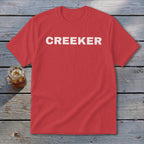 Red t-shirt with white distressed "CREEKER" text, next to a glass of iced tea.