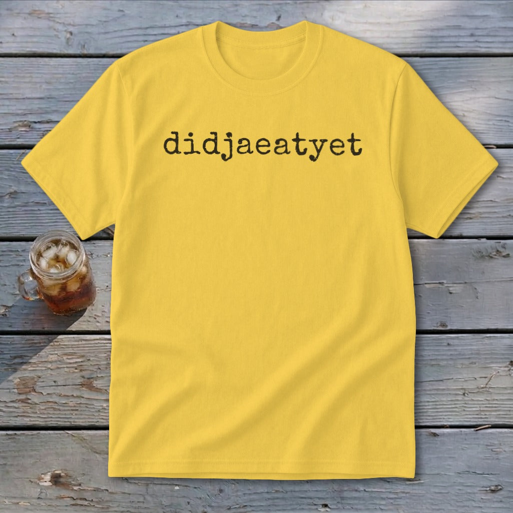 Yellow t-shirt with black text "didjaeatyet" and a glass of iced drink.