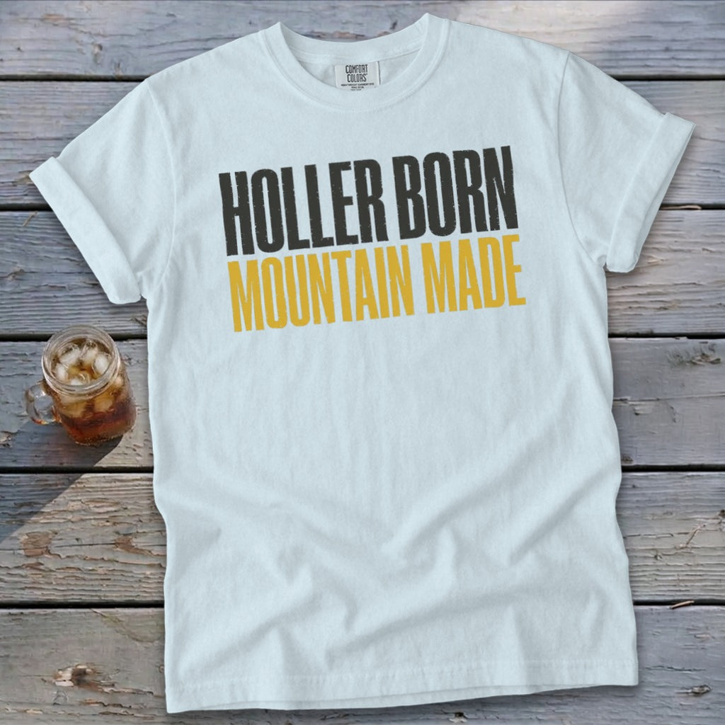 White t-shirt with "HOLLER BORN MOUNTAIN MADE" graphic.