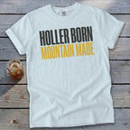 White t-shirt with "HOLLER BORN MOUNTAIN MADE" graphic.