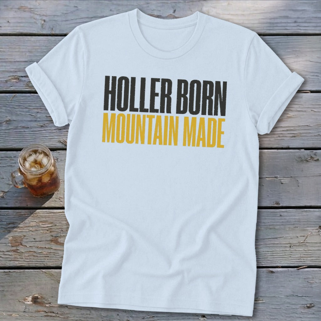 White t-shirt with black and yellow text "HOLLER BORN MOUNTAIN MADE".