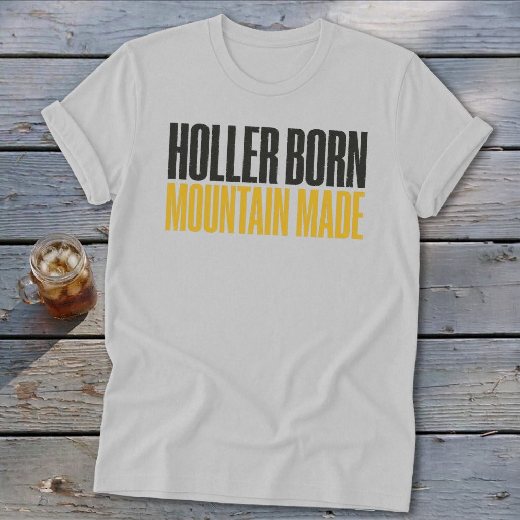 White t-shirt with black and yellow text reading "HOLLER BORN MOUNTAIN MADE".