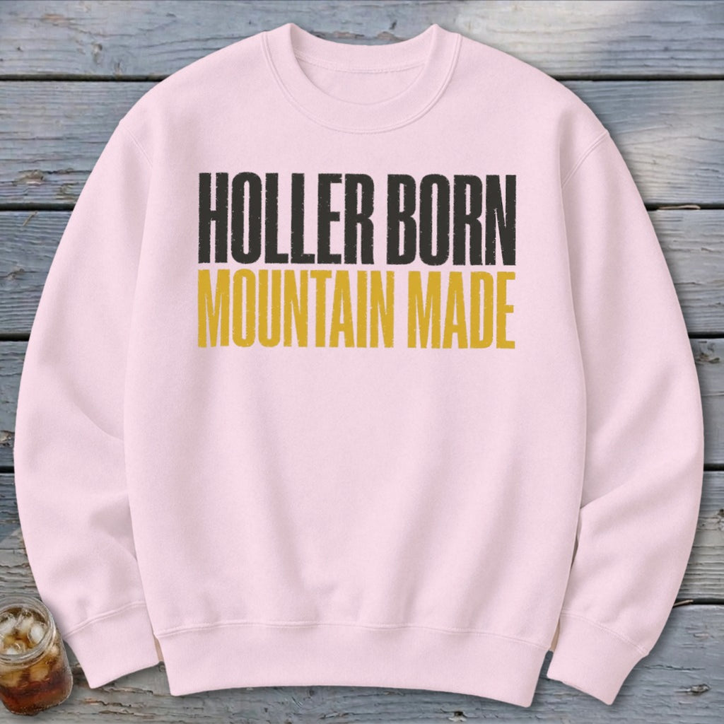 Light pink sweatshirt with black and gold text reading "Holler Born Mountain Made."