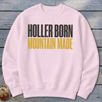 Light pink sweatshirt with black and gold text reading "Holler Born Mountain Made."