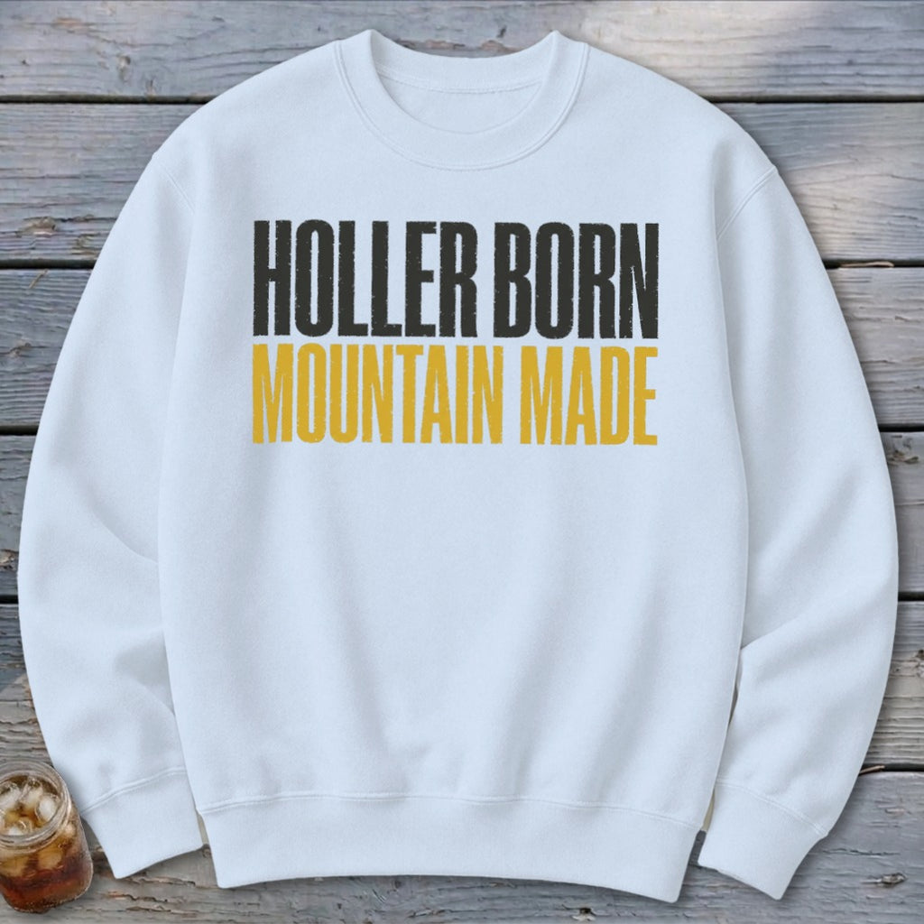 White sweatshirt with black and yellow text reading "Holler Born Mountain Made".